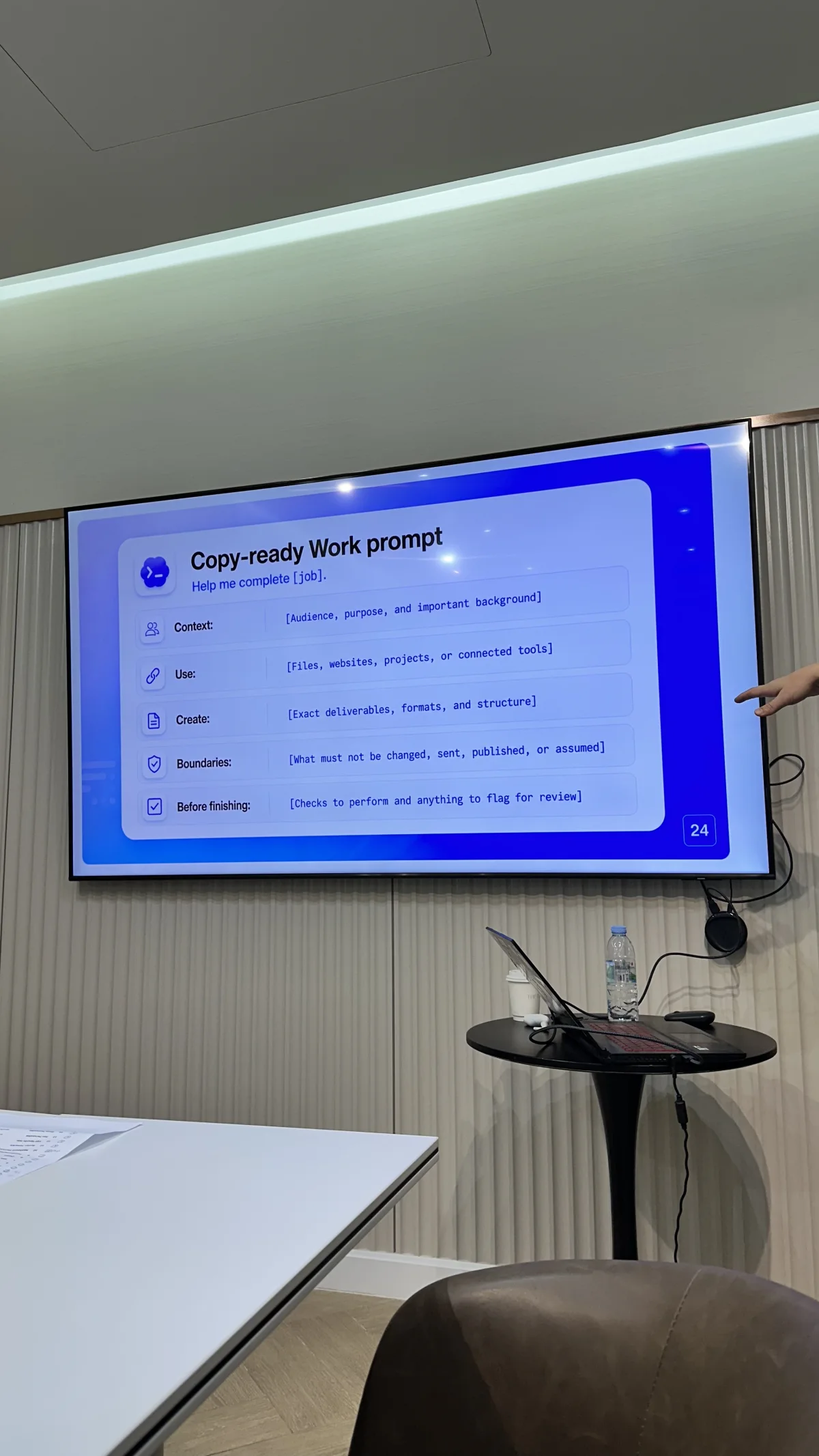The Chiang Mai Codex Community Meetup room with a work-prompt slide on the presentation screen and a laptop table below