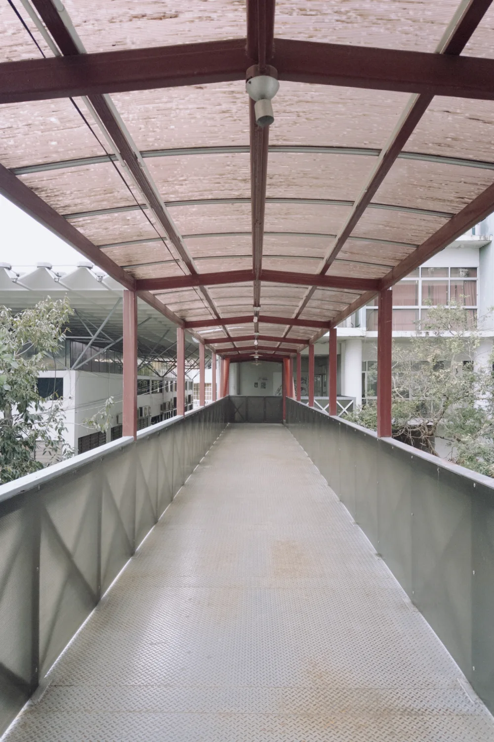 Photograph of the covered red bridge at CMU Engineering on the building walk.
